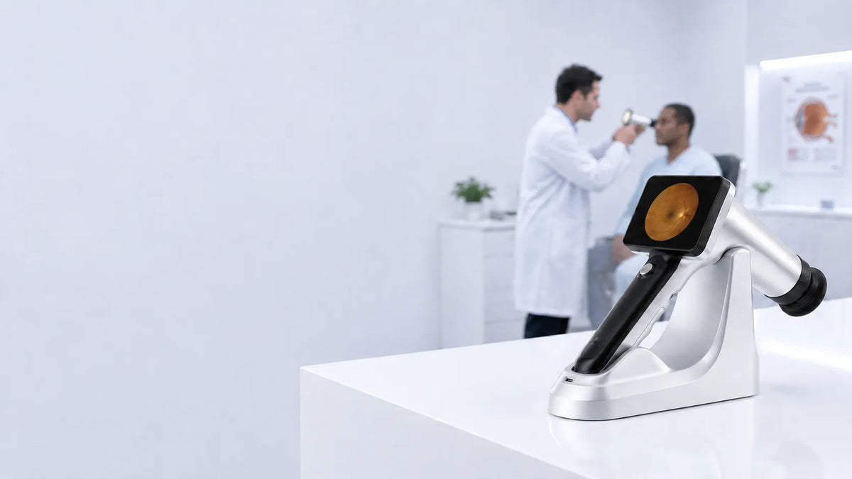DrTono Vista Pro handheld fundus camera displayed on its stand in an ophthalmology clinic during a retinal examination.