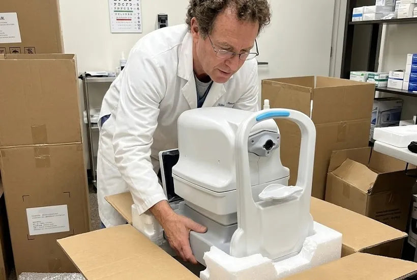 DrTono Vista Station retinal imaging system being removed from its packaging and prepared for installation in an eye clinic.